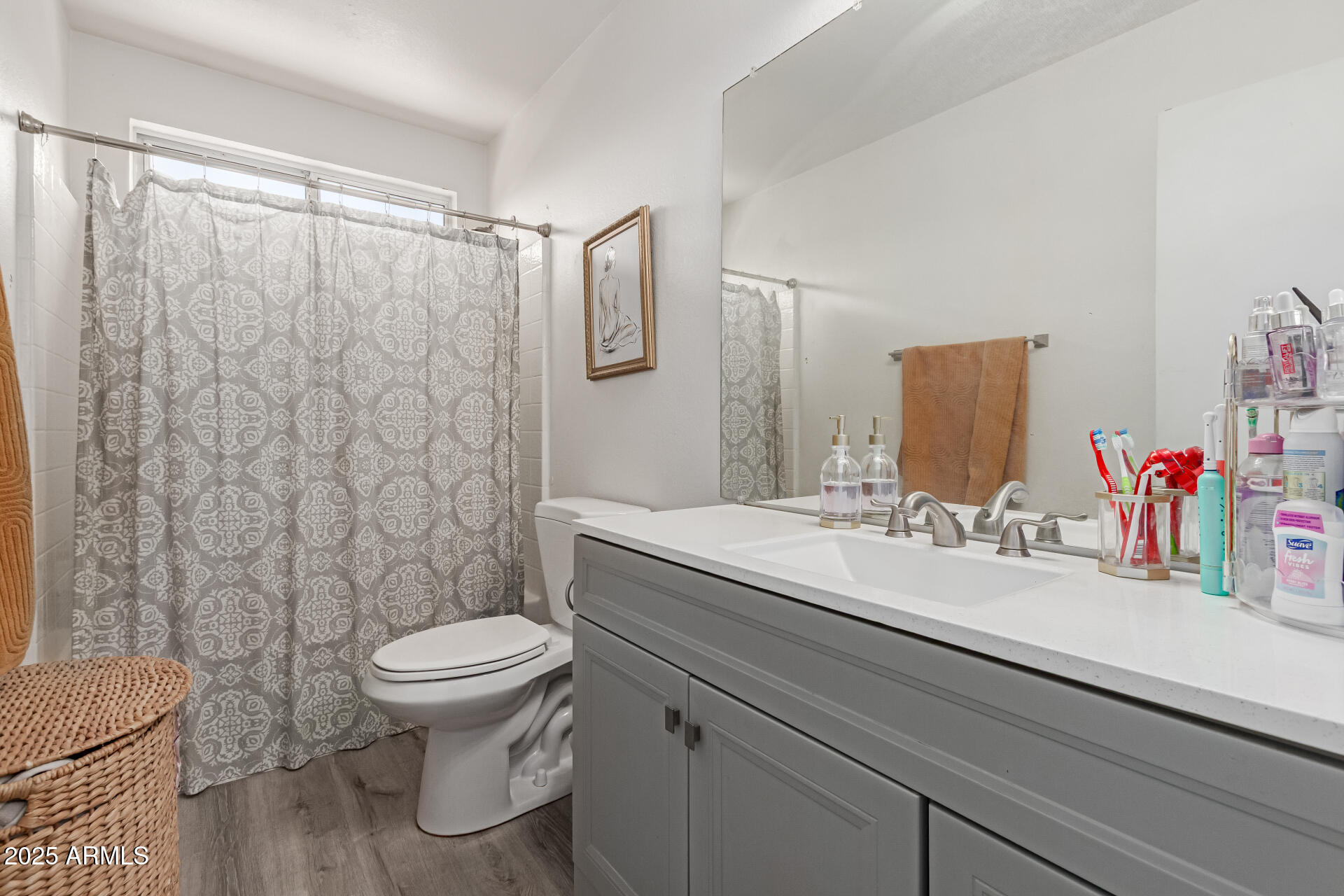 5008 Casper Road Mesa, AZ 85205 - Photo 16 of 25 a bathroom with a granite countertop sink a toilet and a mirror