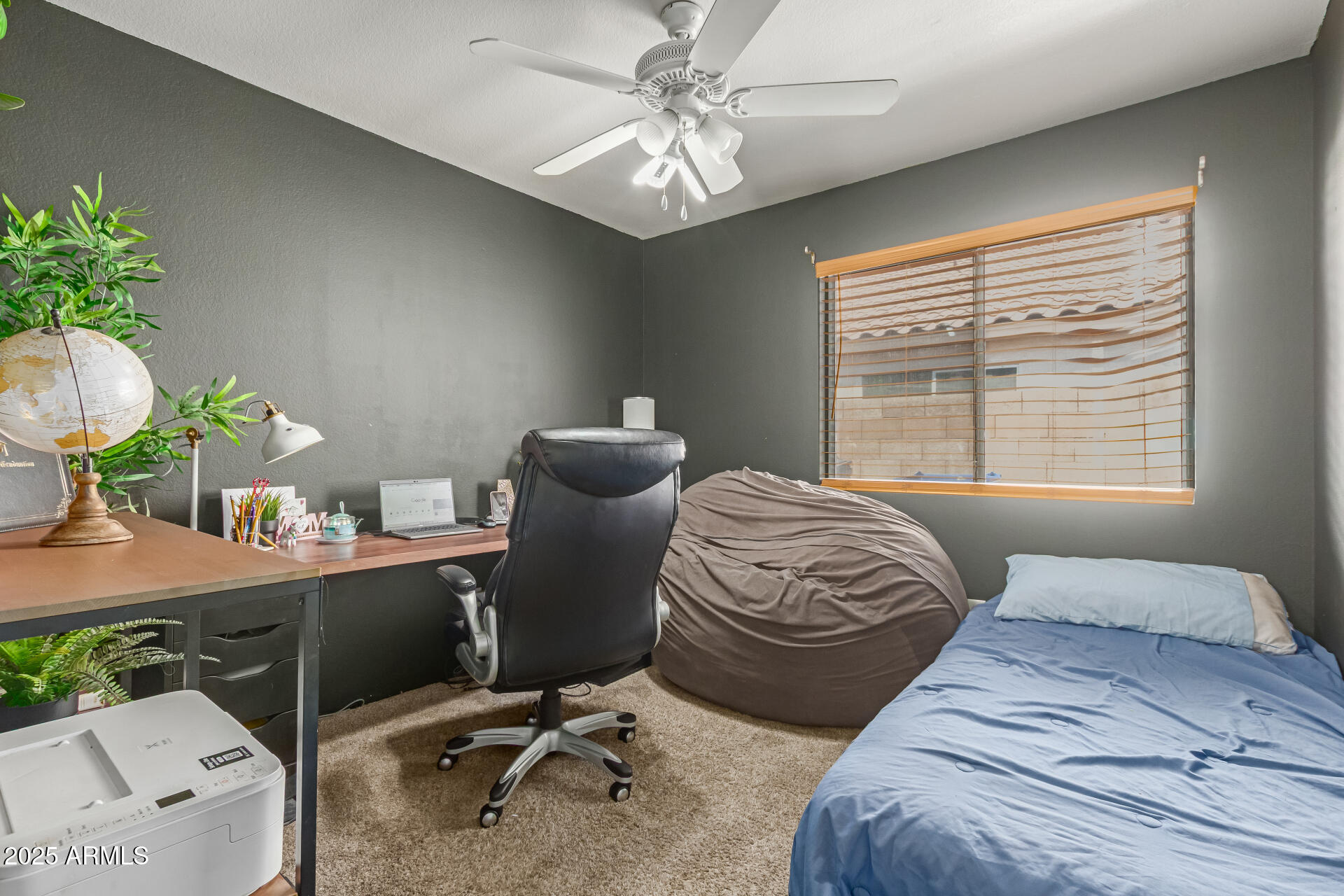5008 Casper Road Mesa, AZ 85205 - Photo 17 of 25 a bedroom with a bed table chair and a window
