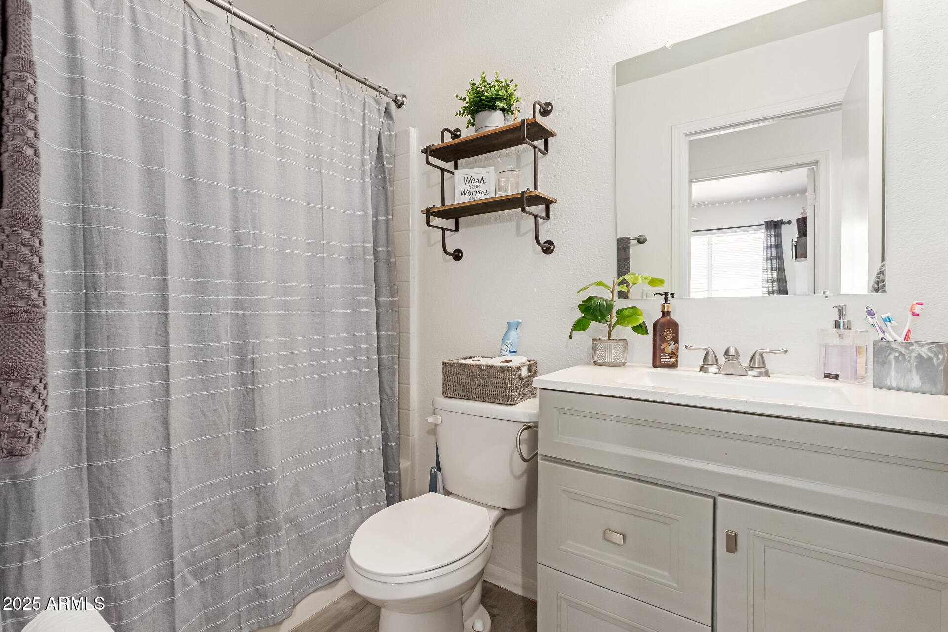 5008 Casper Road Mesa, AZ 85205 - Photo 20 of 25 a bathroom with a sink a toilet and shower curtain