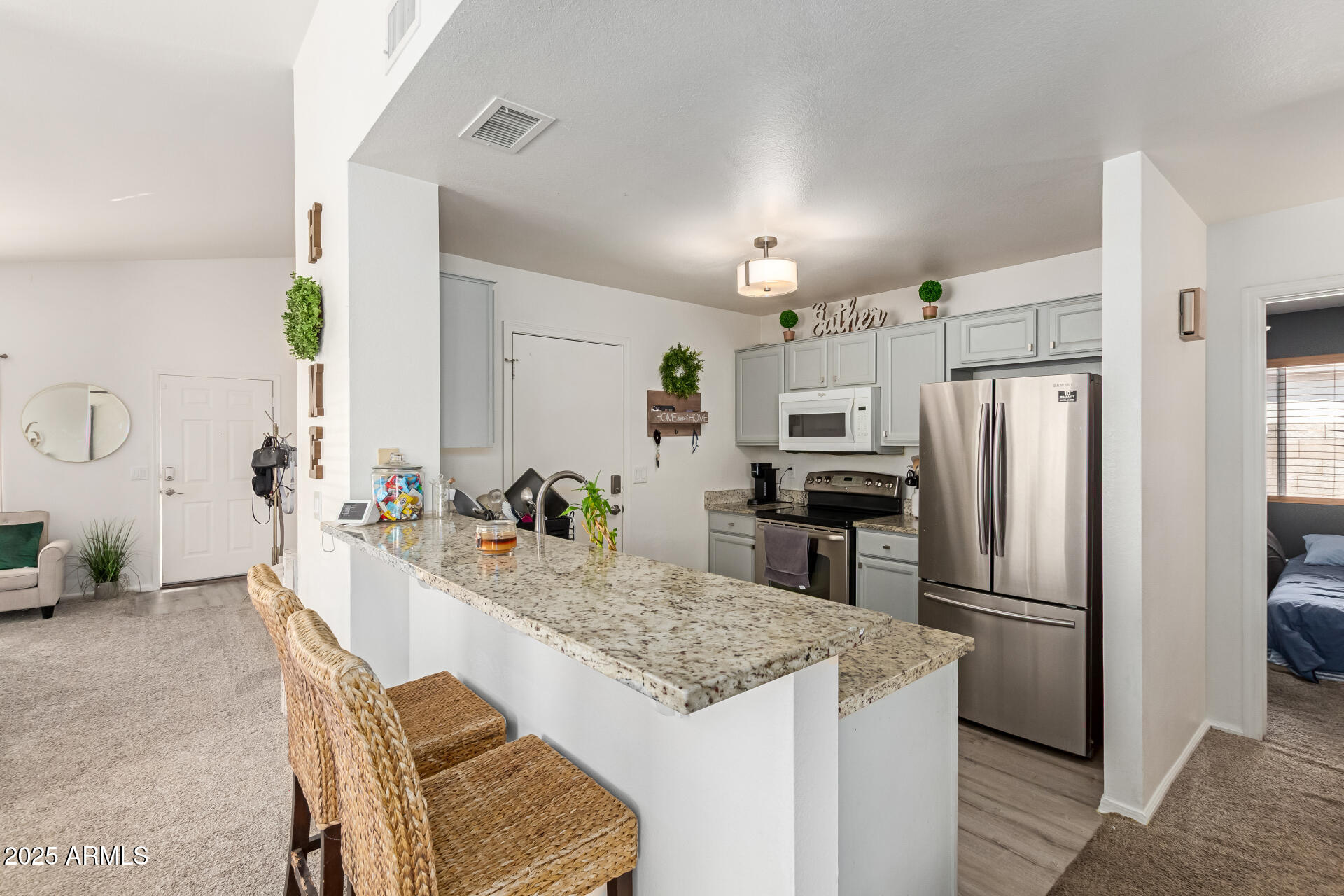 5008 Casper Road Mesa, AZ 85205 - Photo 6 of 25 a kitchen with granite countertop a refrigerator and a stove