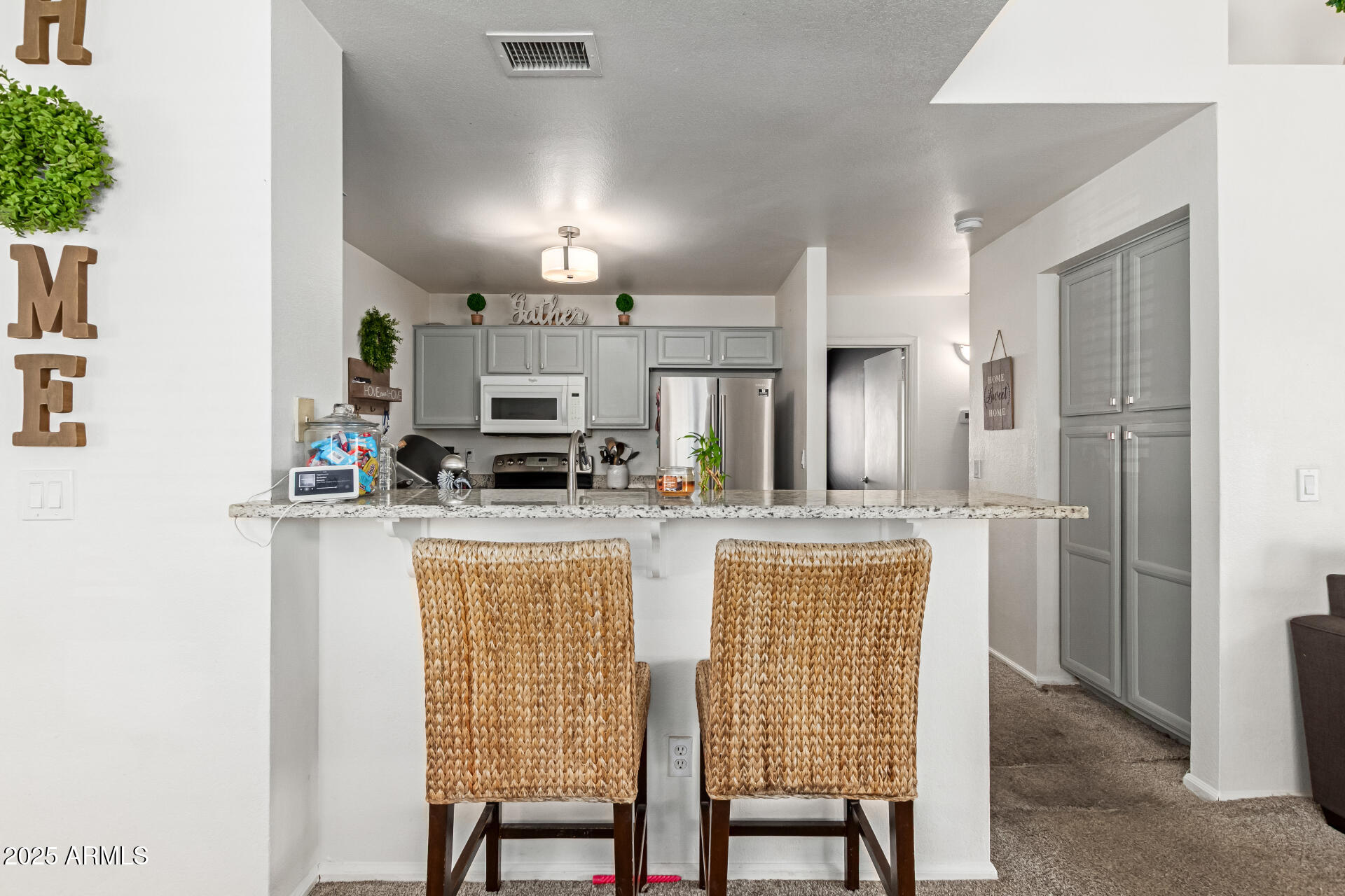 5008 Casper Road Mesa, AZ 85205 - Photo 7 of 25 a kitchen with kitchen island granite countertop lots of counter top space and stainless steel appliances