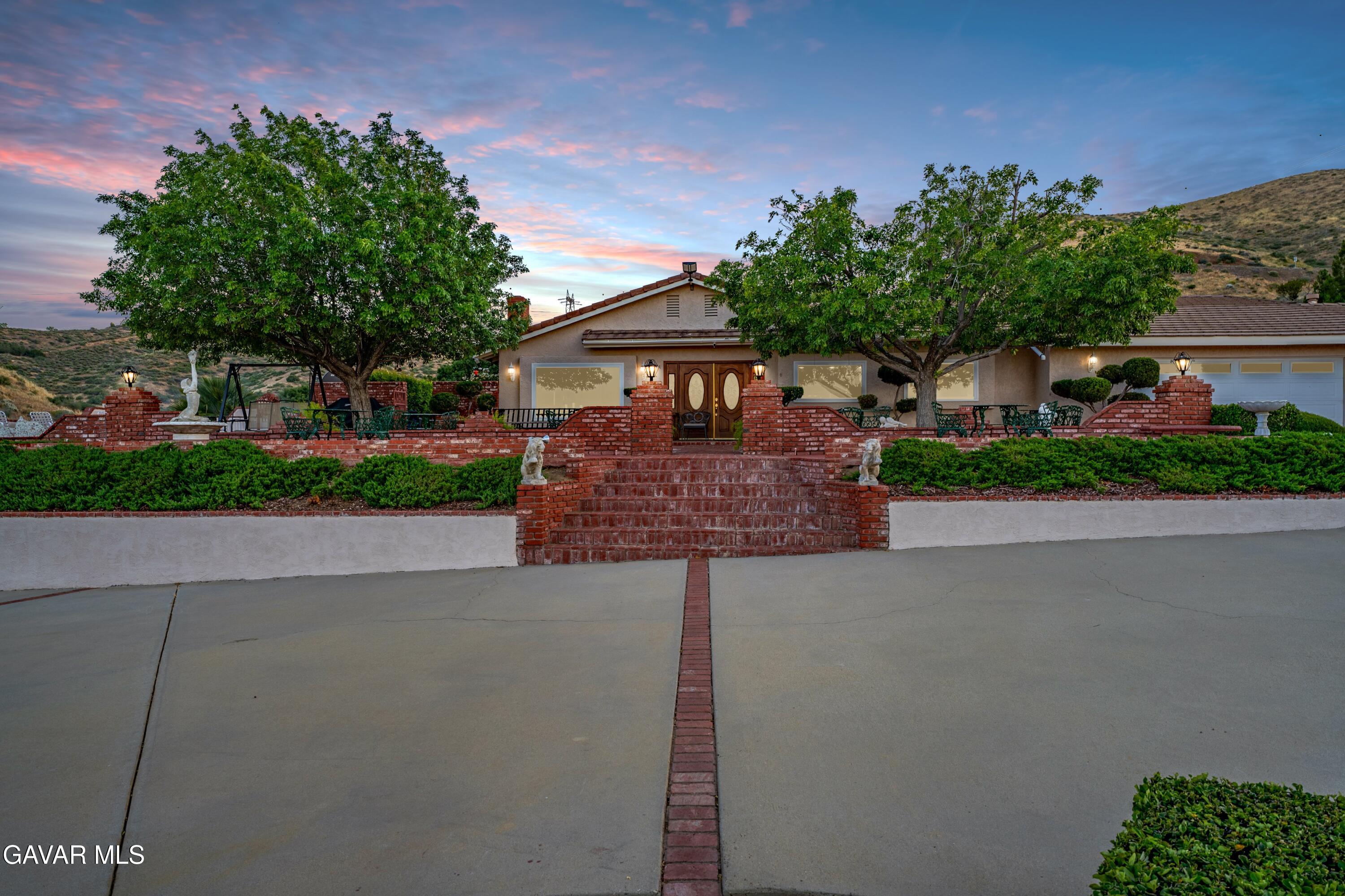 5801 Hacienda Ranch Road Palmdale, CA 93551 - Photo 8 of 69 a front view of a house with garden