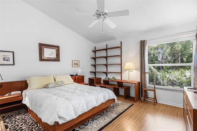 a bedroom with a bed and a lamp on table