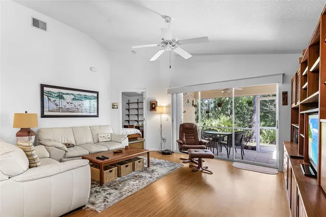 a living room with furniture a rug and a large window