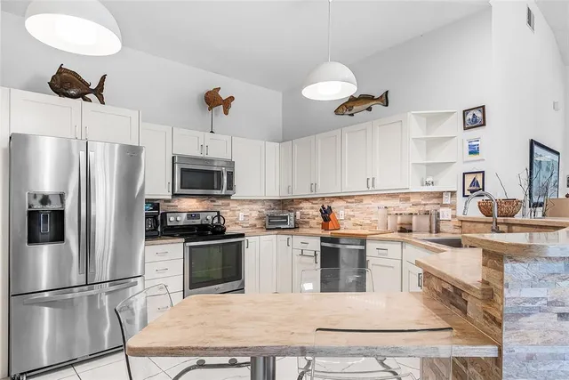a living room with lots of furniture and a wooden floor