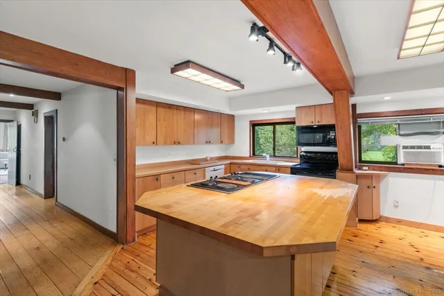 a room with pool table and windows