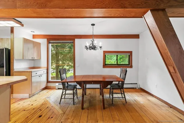 a view of a dining room with furniture window and wooden floor
