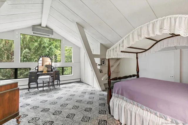 a bedroom with furniture and a window