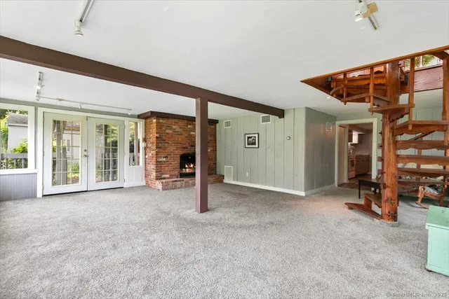 a view of a livingroom with a staircase and a ceiling fan