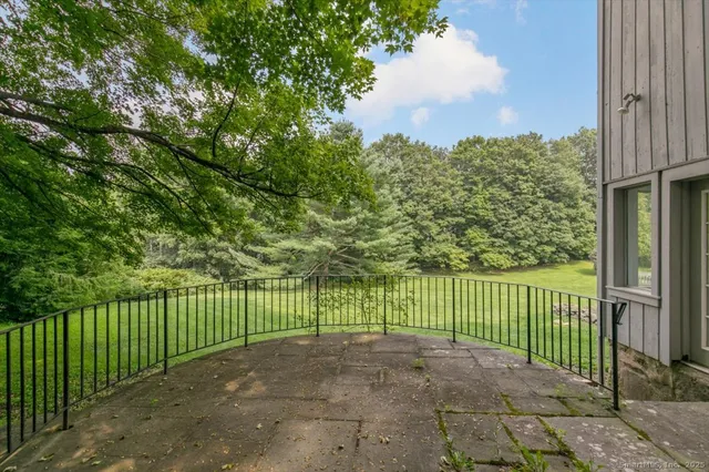 a view of house with backyard and outdoor seating