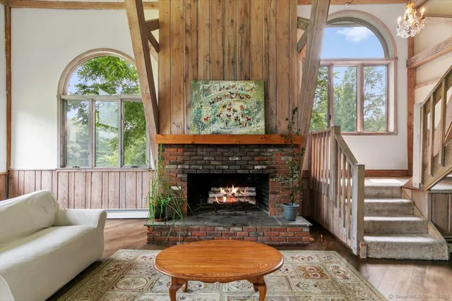 a living room with a fireplace and a large window
