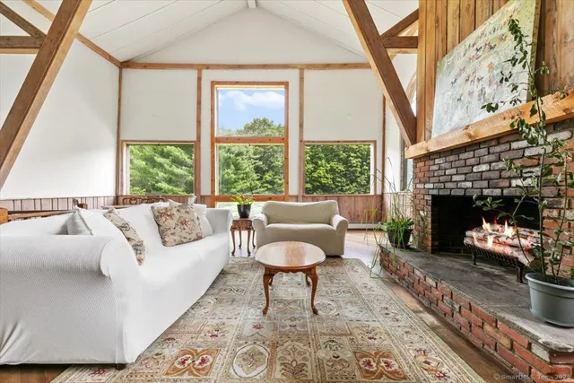 a living room with furniture a fireplace and a table