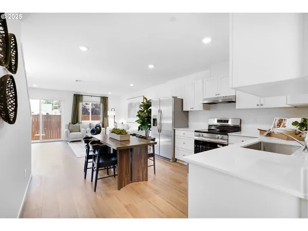 a kitchen with sink cabinets and dining table