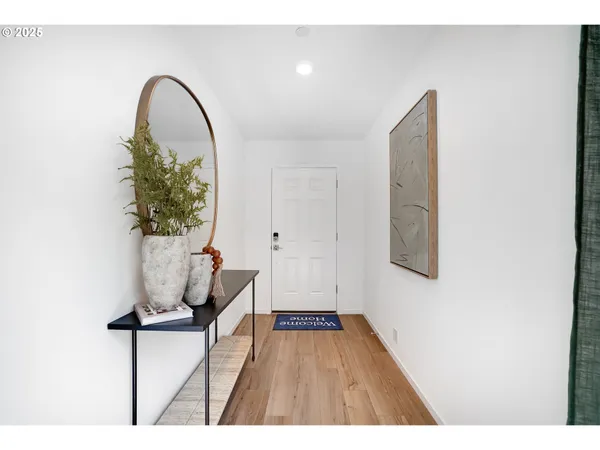 a view of a room with wooden floor and potted plant