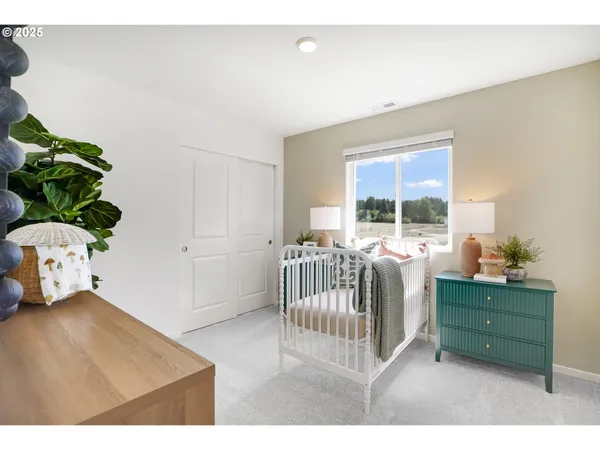 a bedroom with furniture and a potted plant
