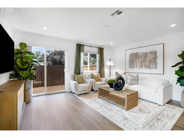 a living room with furniture and a potted plant