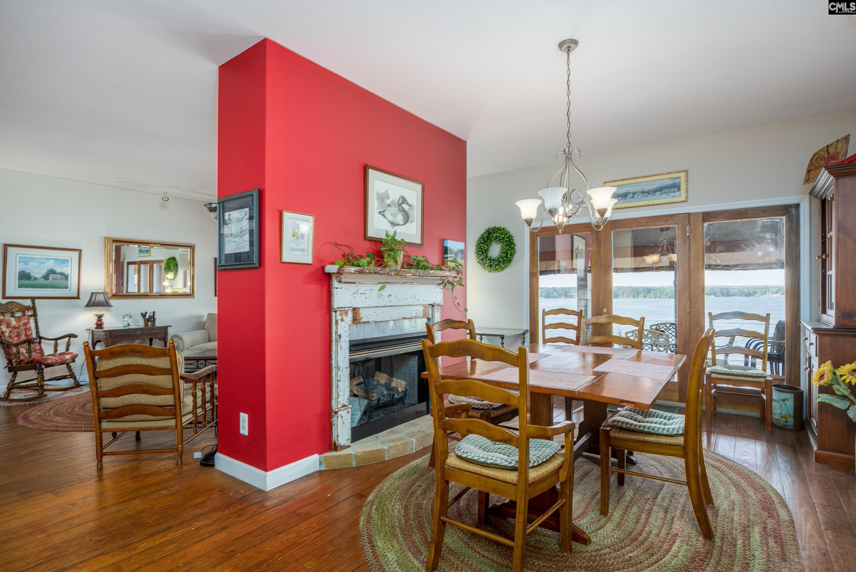 2577 Harbor View Road Camden, SC 29020 - Photo 17 of 42 a dining room with furniture a chandelier and wooden floor