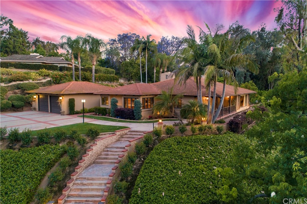 a view of a house with garden and a pond