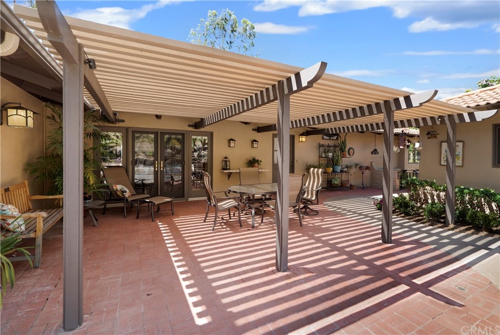 6800 Hawarden Drive Riverside, CA 92506 - Photo 37 of 57 a view of a patio with dining table and chairs with wooden floor and fence