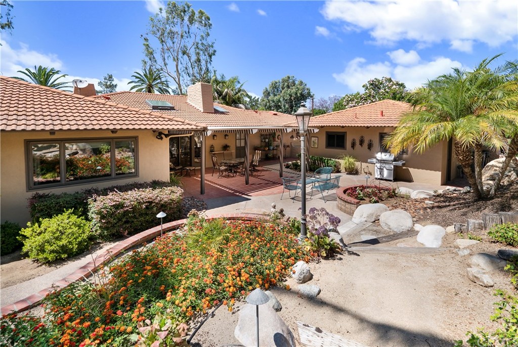 6800 Hawarden Drive Riverside, CA 92506 - Photo 42 of 57 a view of a patio with table and chairs potted plants