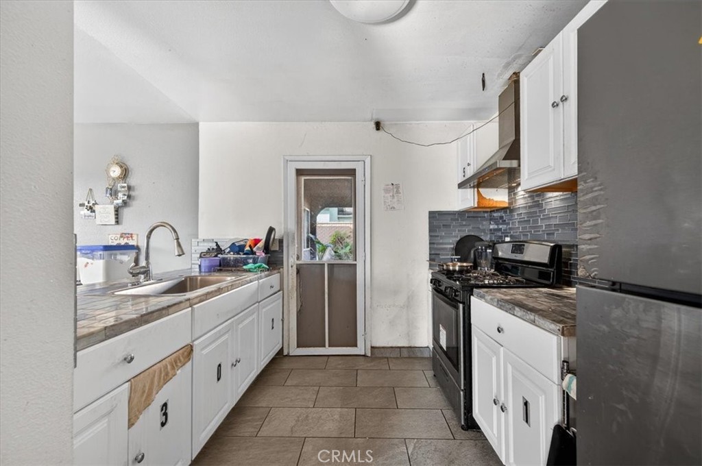 705 South C Madera, CA 93638 - Photo 20 of 50 a kitchen with granite countertop a sink and white stainless steel appliances