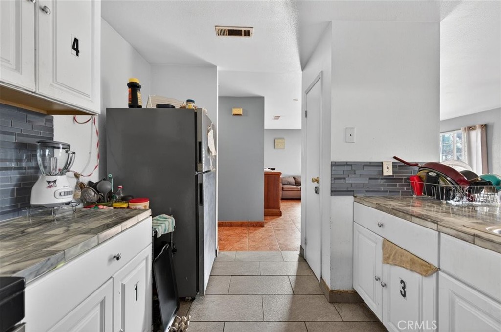 705 South C Madera, CA 93638 - Photo 23 of 50 a kitchen with stainless steel appliances granite countertop a refrigerator and a sink