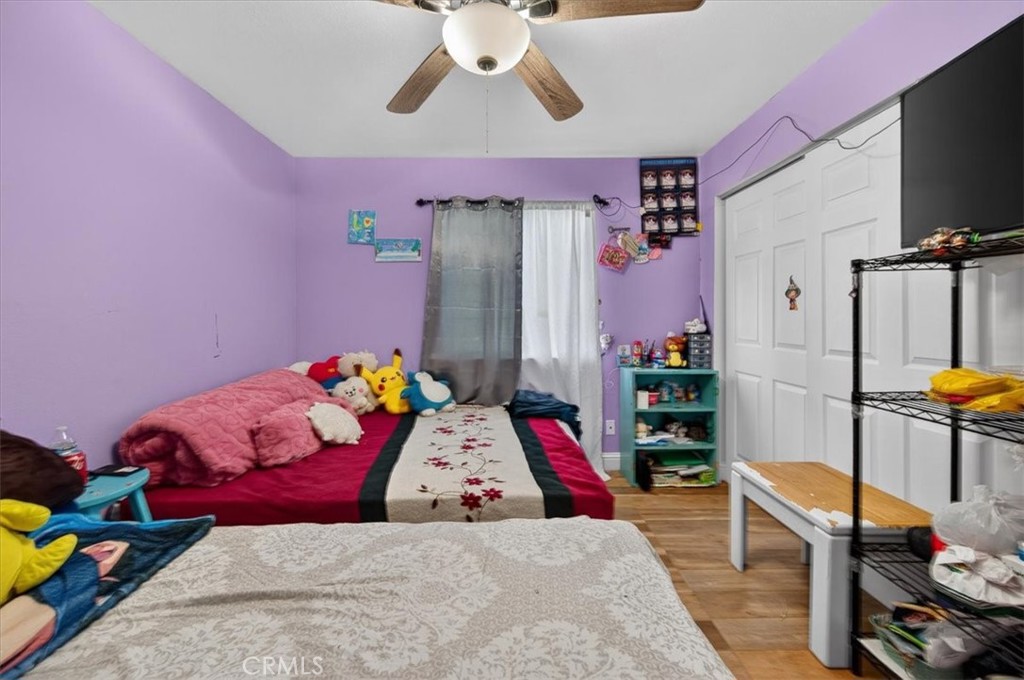 705 South C Madera, CA 93638 - Photo 34 of 50 a bedroom with a bed and a chandelier