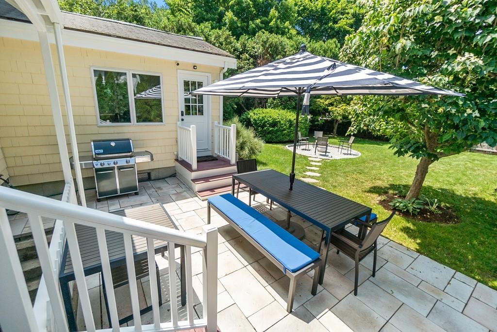 20 Cavanagh Road Wellesley, MA 02481 - Photo 27 of 28 a view of a patio with a table chairs and a backyard