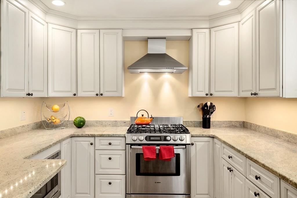 20 Cavanagh Road Wellesley, MA 02481 - Photo 9 of 28 a kitchen with white cabinets and white appliances