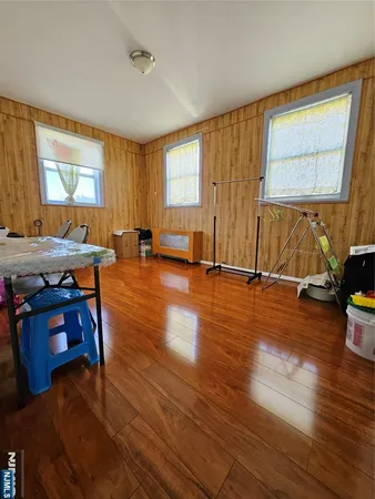 a view of a living room with furniture and wooden floor