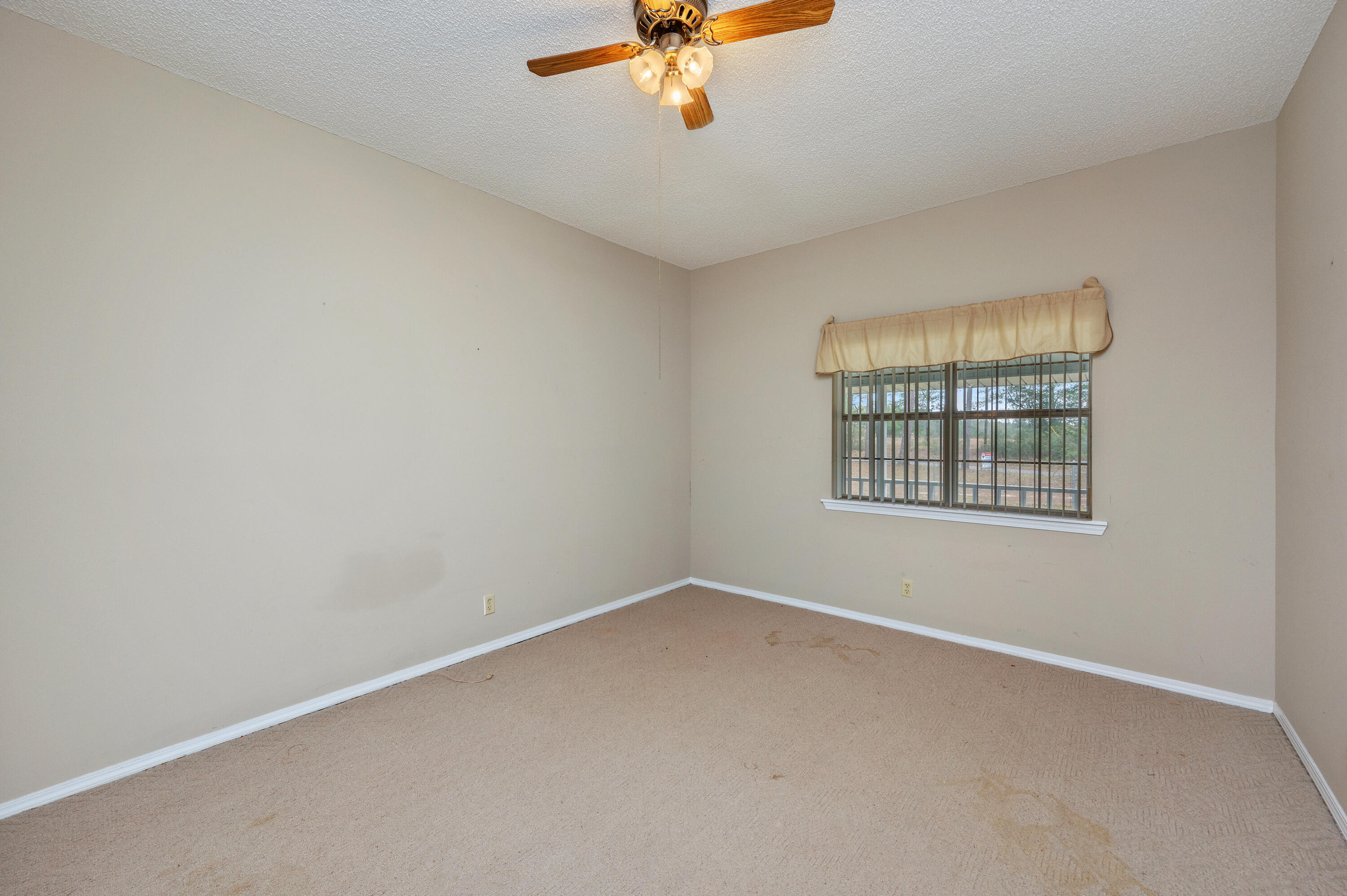 6433 Old River Road Baker, FL 32531 - Photo 14 of 27 an empty room with a window