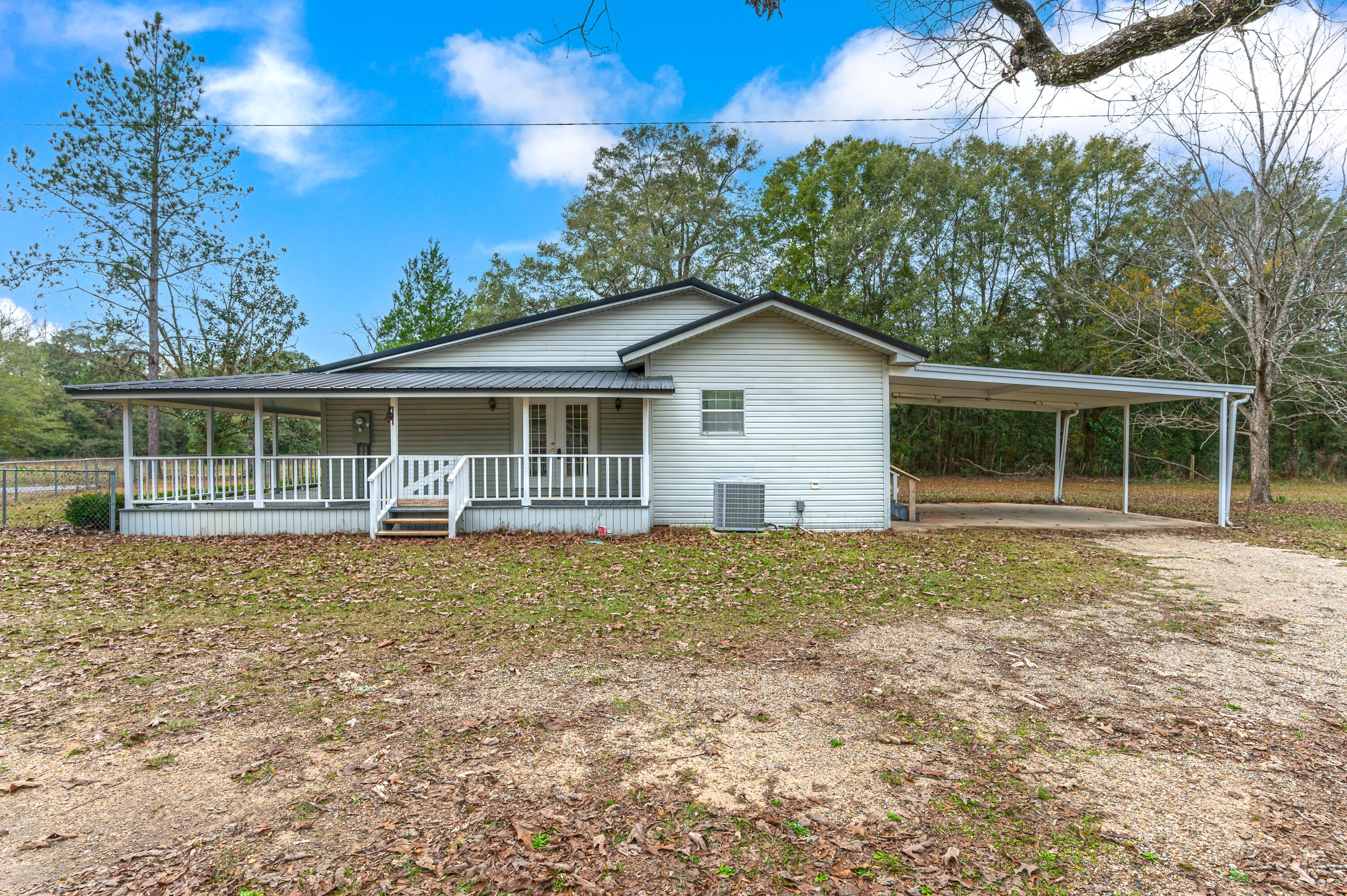 6433 Old River Road Baker, FL 32531 - Photo 3 of 27 a house with trees in the background