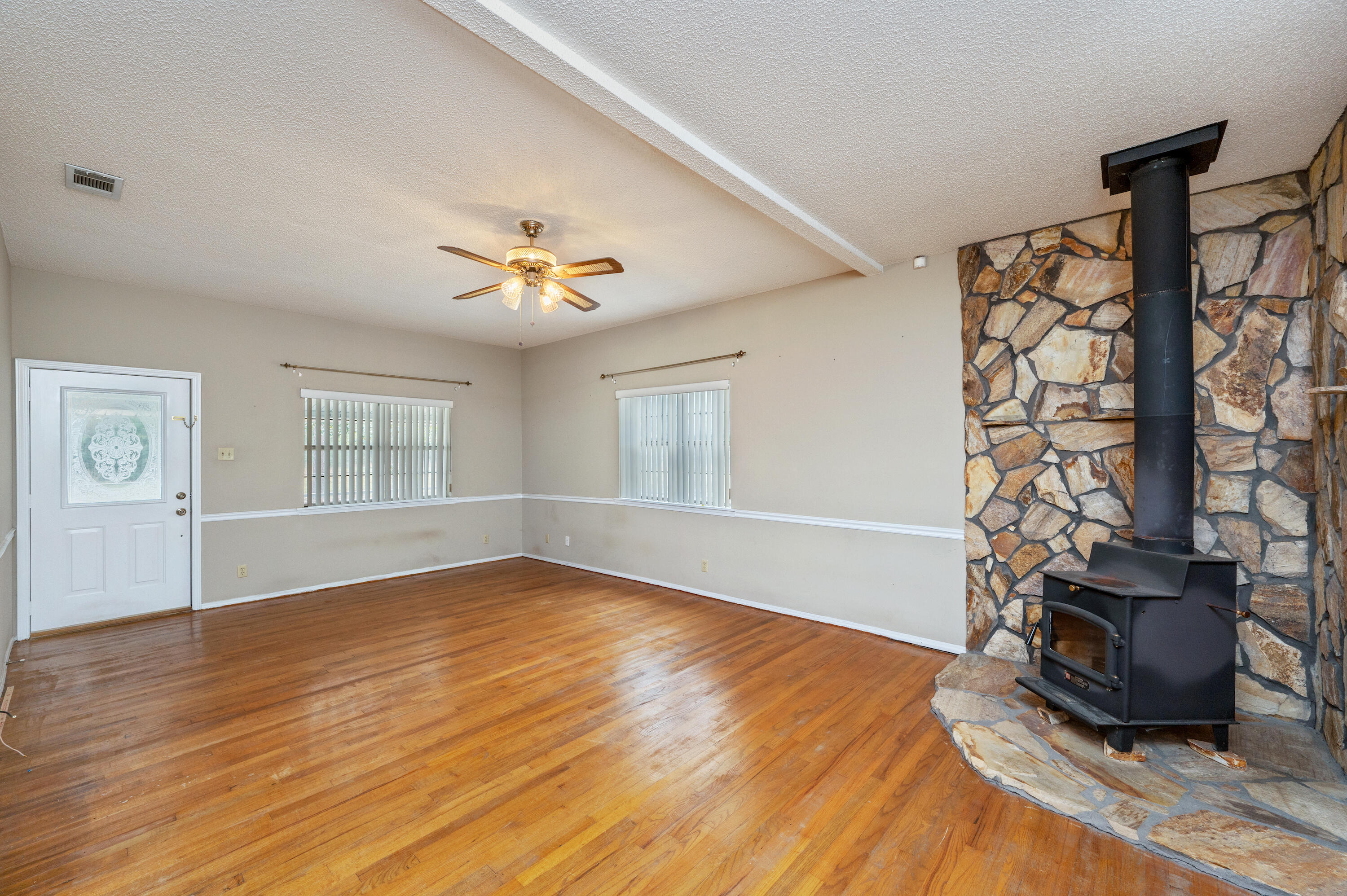 6433 Old River Road Baker, FL 32531 - Photo 7 of 27 a view of an empty room with wooden floor and a window