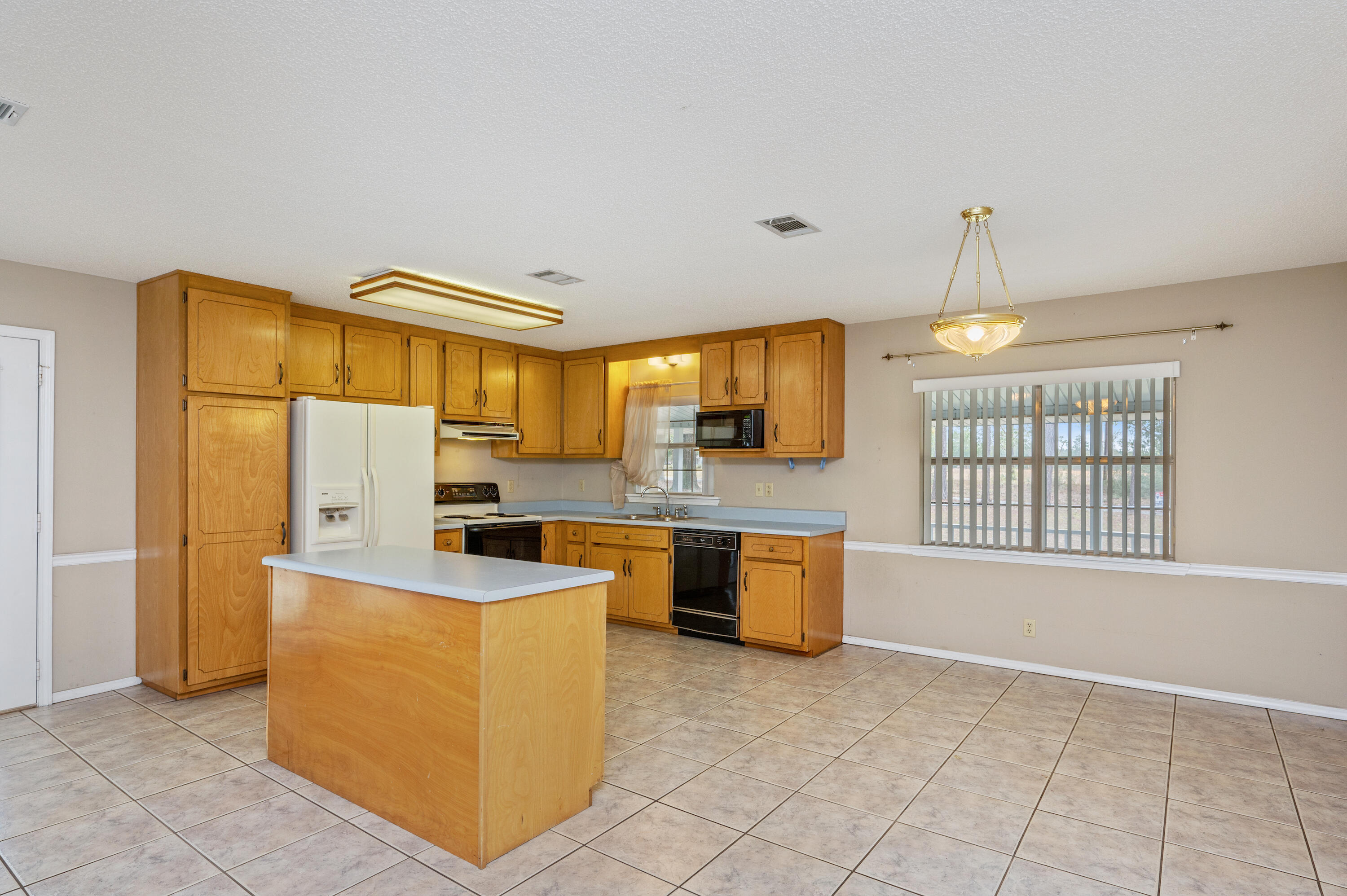 6433 Old River Road Baker, FL 32531 - Photo 9 of 27 a kitchen with stainless steel appliances granite countertop a stove and a sink