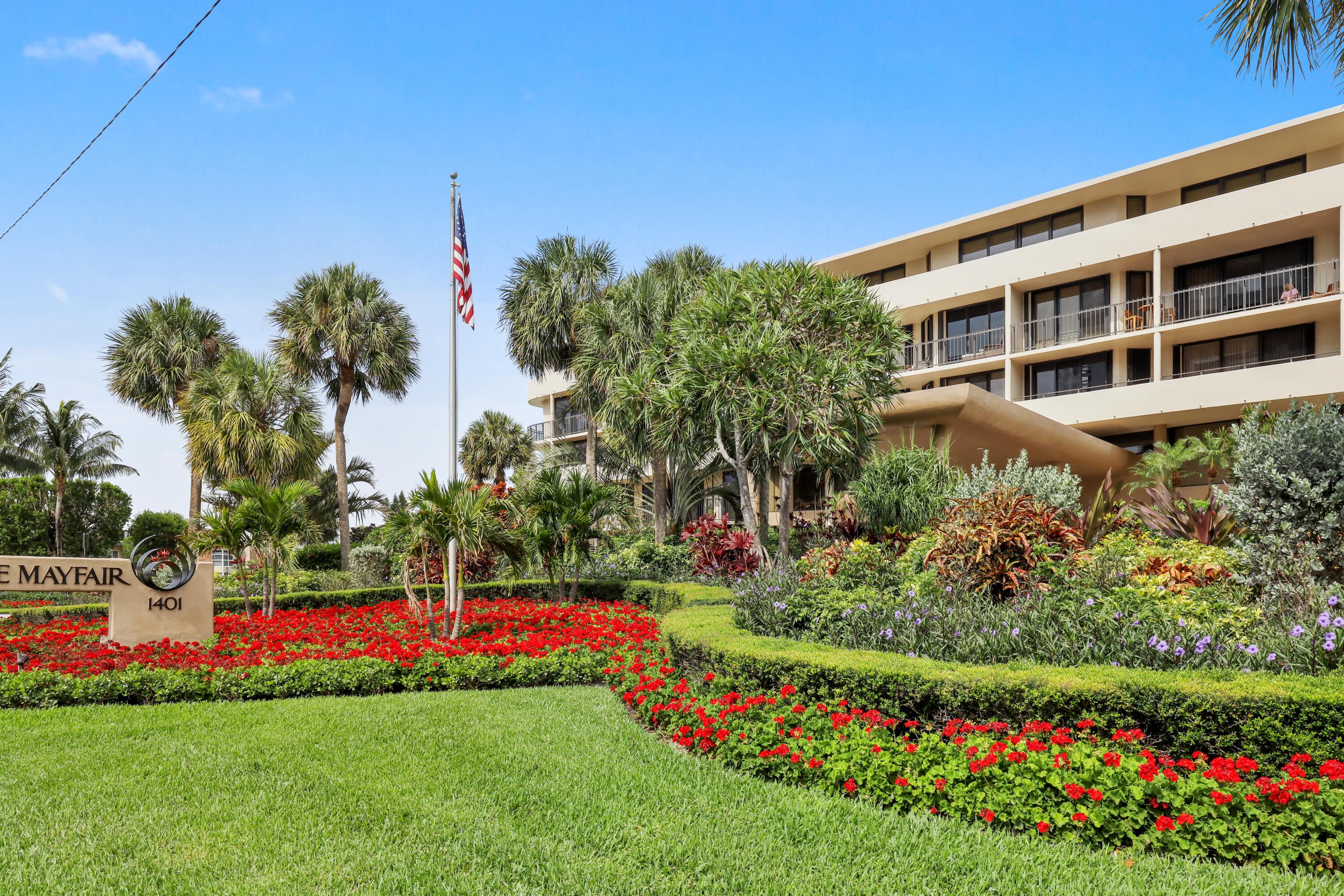 a view of a house with a big yard and potted plants