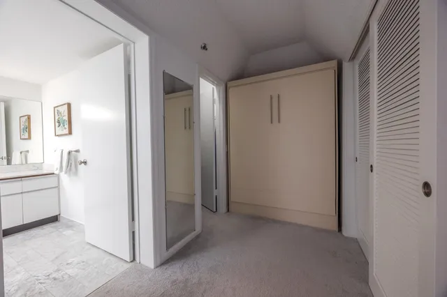 a view of a hallway to rooms