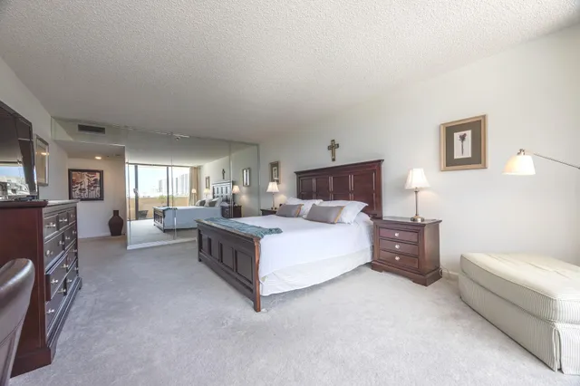 a bedroom with a bed couch and a view living room