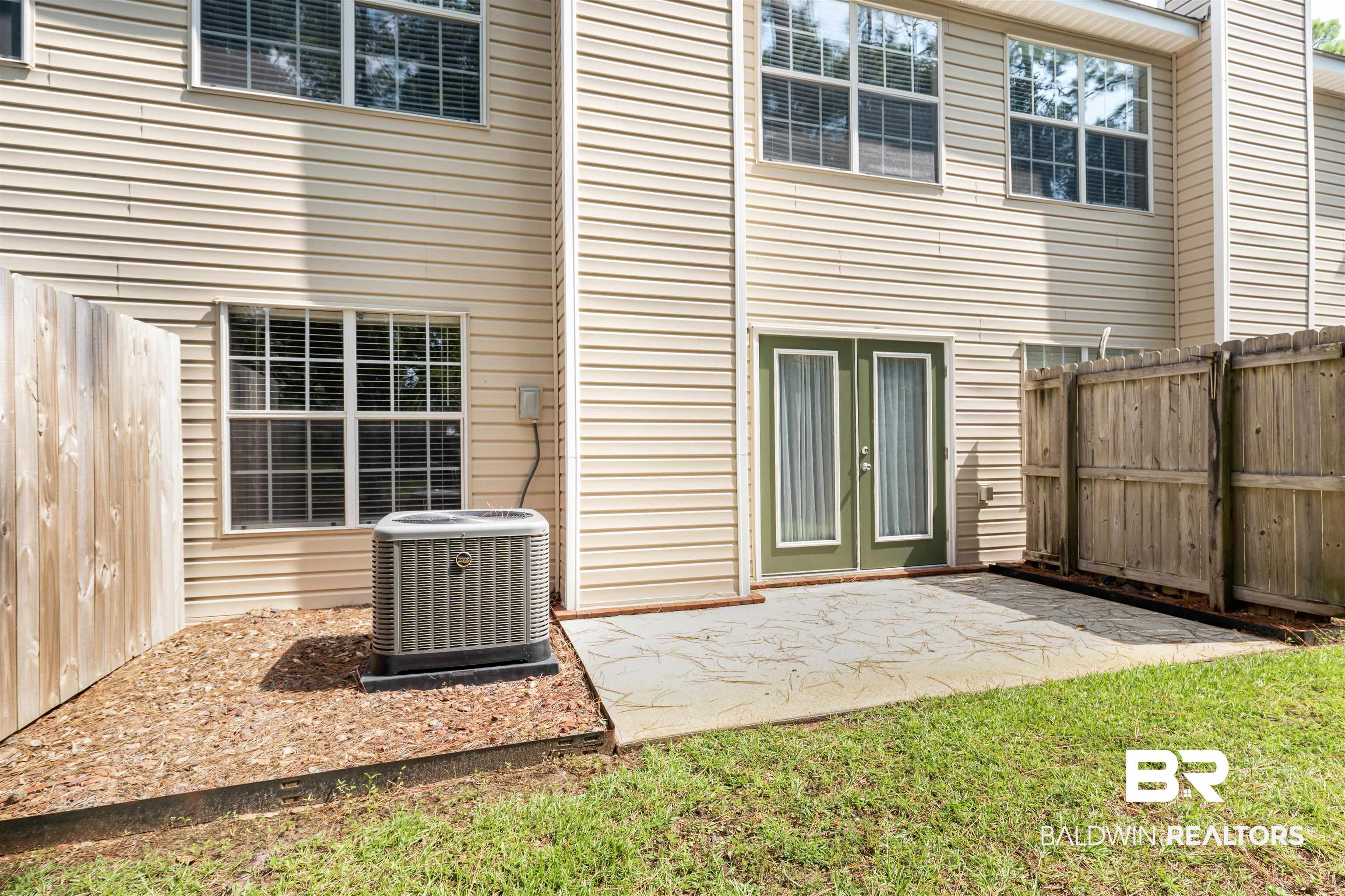 1517 Regency Road, Unit 85 Gulf Shores, AL 36542 - Photo 21 of 32 Back of property with a patio area and central AC unit