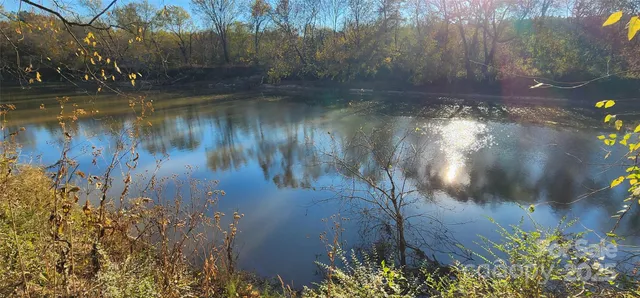 a view of water with a yard