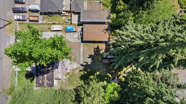 an aerial view of a house with a yard and lake view