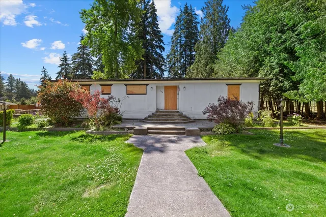 a front view of a house with garden
