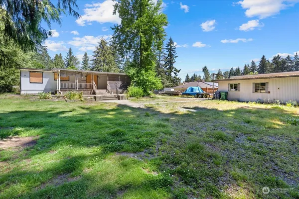 a house view with a sitting space and garden