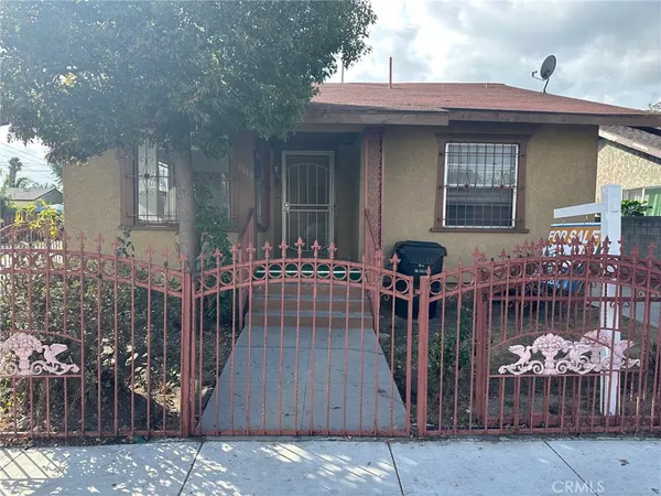 a view of a house with wooden fence