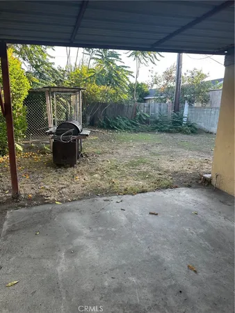 a view of a porch with furniture and garden