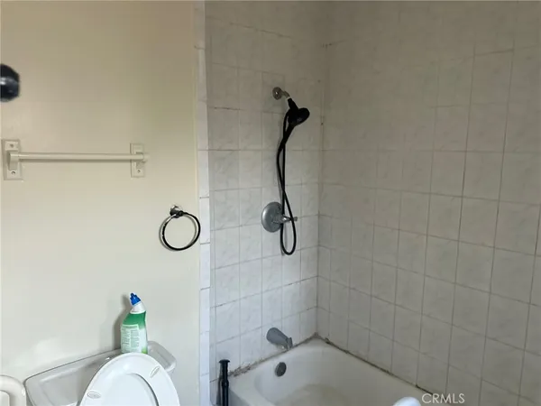 a bathroom with a shower and a toilet