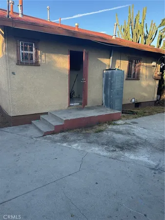 a backyard of a house with barbeque oven