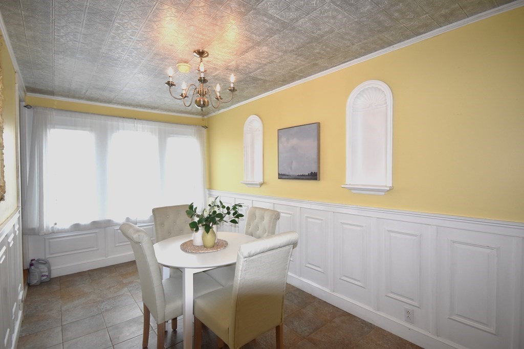 213 Marion Road Rochester, MA 02770 - Photo 11 of 18 a view of a dining room with furniture and a chandelier