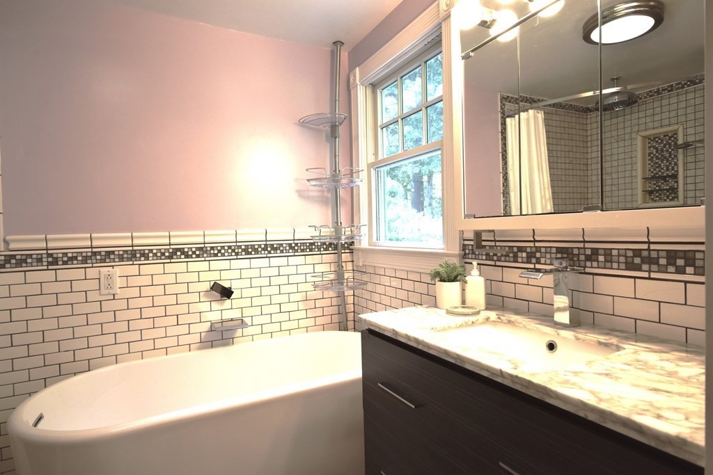 213 Marion Road Rochester, MA 02770 - Photo 15 of 18 a bathroom with a granite countertop sink and a bathtub