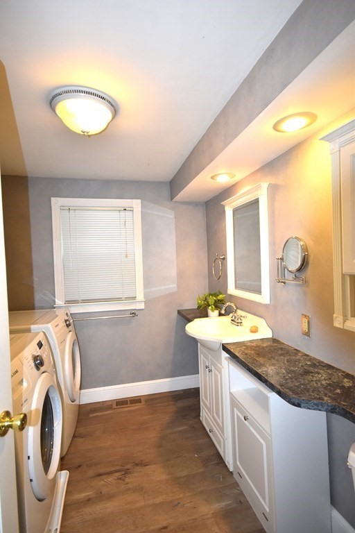 213 Marion Road Rochester, MA 02770 - Photo 17 of 18 a spacious bathroom with a granite countertop sink and a mirror