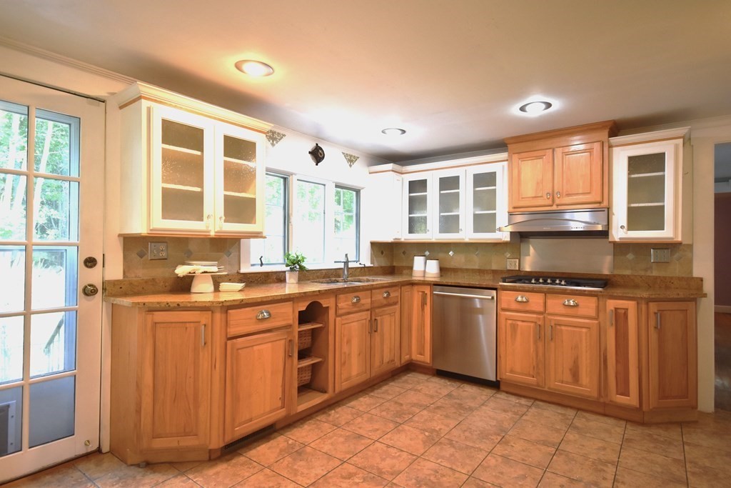 213 Marion Road Rochester, MA 02770 - Photo 8 of 18 a kitchen with stainless steel appliances granite countertop stove top oven and sink